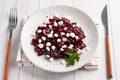 Salad of boiled beetroot and grain curd with sesame seeds on a plate. Royalty Free Stock Photo