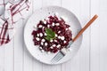 Salad of boiled beetroot and grain curd with sesame seeds on a plate. Copy space Royalty Free Stock Photo