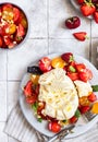 Salad with burrata cheese, cherry tomatoes and strawberry with microgreen and olive oil. Traditional Italian burrata cheese. Royalty Free Stock Photo