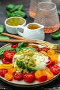 Salad burrata cheese tomatoes and green pesto. Delicious balanced food concept. superfood concept. Healthy, clean eating. Vegan or Royalty Free Stock Photo