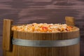 Salad from cabbage and carrots in oak barrel, on a wooden background Royalty Free Stock Photo