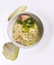 Salad with cabbage leaves and mushrooms in white bowl. close up