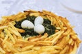 Salad called wood grouse nest. Fried potatoes, boiled quail eggs and green dill in dish Royalty Free Stock Photo