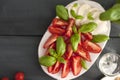 Salad with caprese on a black background. Classical Italian food. Copy space, flat lay