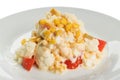 Salad of cauliflower with fresh tomato and corn, with mayonnaise on a white plate Royalty Free Stock Photo