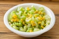 Salad celery with corn in white bowl