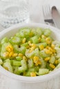 Salad celery with corn in white bowl