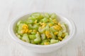 Salad celery with corn in white bowl