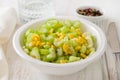Salad celery with corn in white bowl