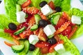 Salad with cheese tomatoes, peppers, olives and herbs in a close-up Royalty Free Stock Photo