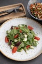 Salad with cherry tomatoes, cucumbers and arugula and bowl with tasty rice, meat and vegetables Royalty Free Stock Photo