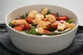 Salad with cherry tomatoes, mixed grens and cheese in white bowl on concrete background Royalty Free Stock Photo