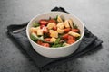 Salad with cherry tomatoes, mixed grens and cheese in white bowl on concrete background Royalty Free Stock Photo