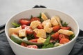 Salad with cherry tomatoes, mixed grens and cheese in white bowl on concrete background Royalty Free Stock Photo