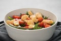 Salad with cherry tomatoes, mixed grens and cheese in white bowl on concrete background Royalty Free Stock Photo