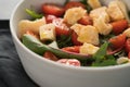 Salad with cherry tomatoes, mixed grens and cheese in white bowl on concrete background Royalty Free Stock Photo