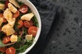 Salad with cherry tomatoes, mixed grens and cheese in white bowl on concrete background Royalty Free Stock Photo