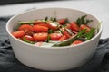 Salad with cherry tomatoes and mixed grens in white bowl on concrete background Royalty Free Stock Photo