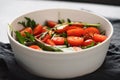 salad with cherry tomatoes and mixed grens in white bowl on concrete background Royalty Free Stock Photo