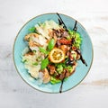 Salad with chicken, grilled vegetables and parmesan. In the plate. Rustic style. Top view. Royalty Free Stock Photo