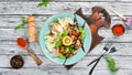 Salad with chicken, grilled vegetables and parmesan. In the plate. Rustic style. Top view. Royalty Free Stock Photo