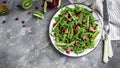 Salad with chicken liver. Fresh vegetable salad. Meat salad with liver, kiwi and pomegranate and fresh arugula. banner, menu