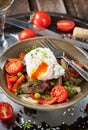 Salad with chicken livers, vegetables and poached egg Royalty Free Stock Photo