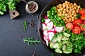 Salad of chickpeas, tomatoes, cucumbers, radish and greens. Royalty Free Stock Photo