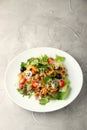 Salad with chiken and green in white plate on light background