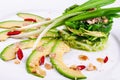 Salad with chuka seaweed, avocado, cucumber, sesame seeds, pine nuts on a white plate Royalty Free Stock Photo