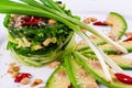 Salad with chuka seaweed, avocado, cucumber, sesame seeds, pine nuts on a white plate Royalty Free Stock Photo