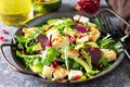 Salad close-up with grilled chicken, avocado, brie cheese, arugula and pomegranate