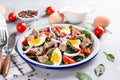 Salad from cod liver, eggs and vegetables on a plate. Nutritious, useful