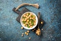 Salad with cooked or canned chickpeas and fresh mint in white bowl on black wooden board