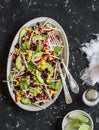 Salad with corn, beans, avocado and tortilla. Mexican black bean salad. On a dark background Royalty Free Stock Photo