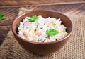 Salad with corn and crab sticks in bowl on wooden table Royalty Free Stock Photo