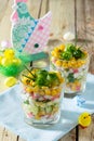 Salad with crab sticks, eggs, corn and cucumber. Festive snack on a wooden table. Easter recipe