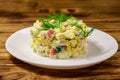 Salad with crab sticks, sweet corn, cucumber, eggs and mayonnaise on wooden table. Top view Royalty Free Stock Photo