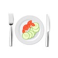 Salad of cucumbers and tomatoes with a knife, fork