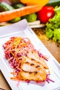 Salad with eel, carrot, red onion, sesame seeds on white plate Royalty Free Stock Photo