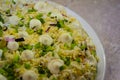 Salad with egg, green onions and with drops of mayonnaise on a large plate. Close-up.