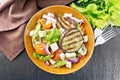 Salad of eggplant with feta and tomatoes on dark board top Royalty Free Stock Photo