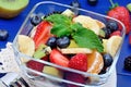 Salad with fresh fruits and berries in a bowl on table Royalty Free Stock Photo
