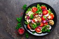 Salad with fresh and grilled vegetables and mushrooms. Vegetable salad with grilled champignons. Vegetable salad on plate Royalty Free Stock Photo