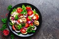 Salad with fresh and grilled vegetables and mushrooms. Vegetable salad with grilled champignons. Vegetable salad on plate