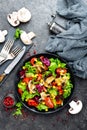 Salad with fresh and grilled vegetables and mushrooms. Vegetable salad with grilled champignons. Vegetable salad on plate Royalty Free Stock Photo