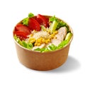 Salad of lettuce, tomato, cucumber, chicken, corn and grated parmesan in cardboard cup on white Royalty Free Stock Photo