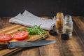 Salad. It is fresh the sliced tomatoes with arugula and seasonings in a white bowl. On a wooden table. Selective focus Royalty Free Stock Photo