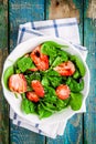 Salad with fresh spinach and strawberries with balsamic sauce and sesame