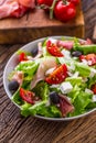 Salad. Fresh summer lettuce salad.Healthy mediterranean salad olives tomatoes parmesan cheese and prosciutto Royalty Free Stock Photo